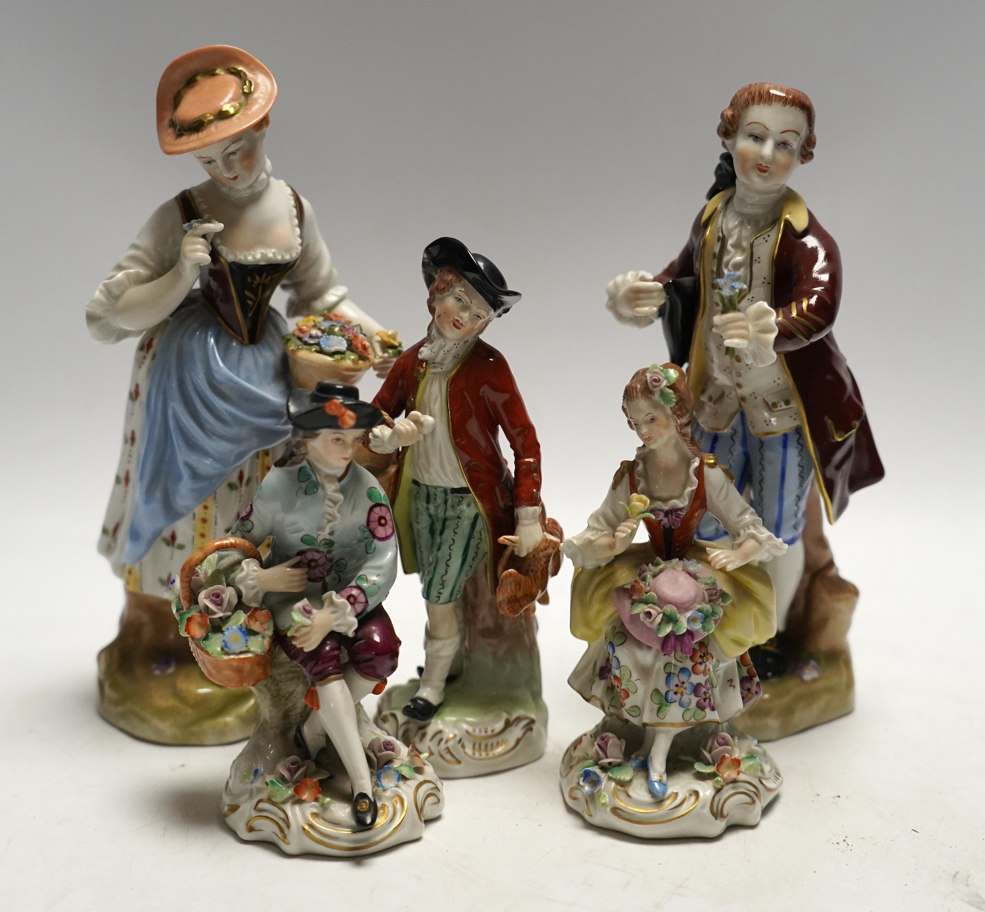 Three Dresden and two Sitzendorf porcelain figures, tallest 20cm